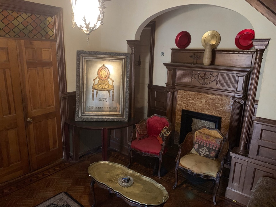 Wood-paneled parlor with fireplace