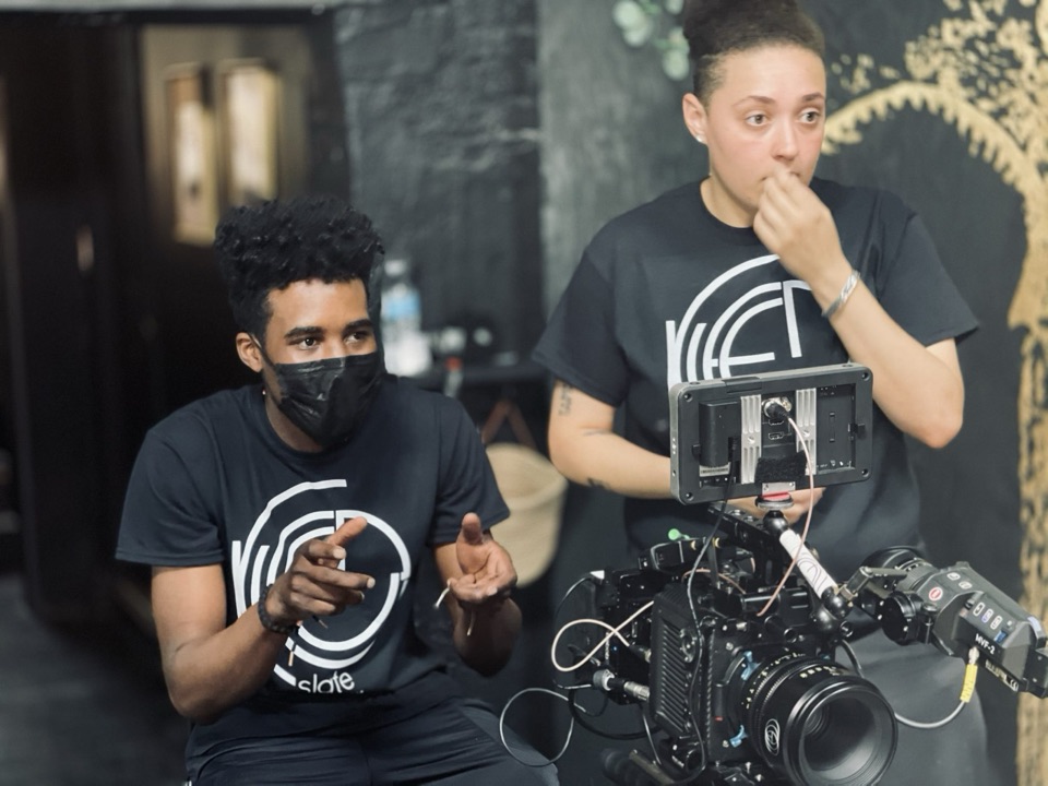 Two crew members at an ARRI camera checking the monitor