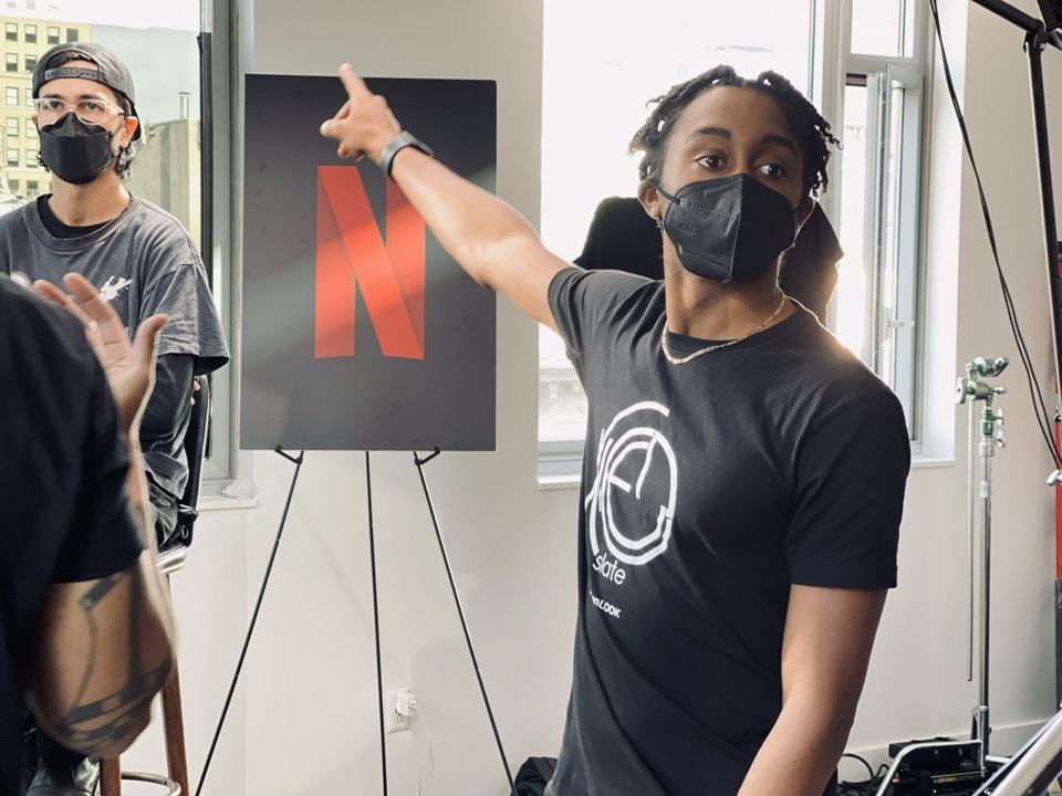 KleenSlate crew in branded tees directing a shot on set